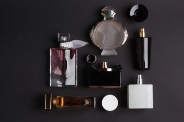 siyah arka plan üzerine farklı parfüm şişeleri