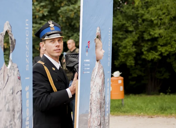 Een brandweerman uit Polen poseren voor foto met kind — Stockfoto