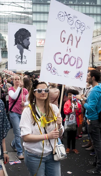 Elaborately dressed participant, with placard during Gay Pride P — Stock Photo, Image