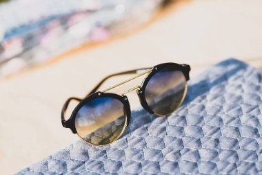 Yuvarlak mercekli güneş gözlükleri güneşli bir günde açık havada çekiliyor. Seçici Odaklanma