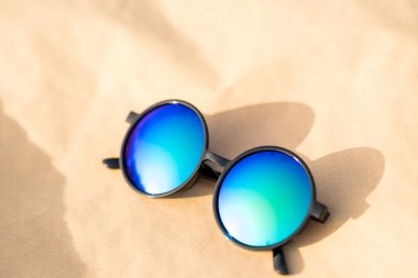 Güneşli bir günde, açık havada büyük mavi mercekli güneş gözlükleri fırlatılır. Seçici Odaklanma