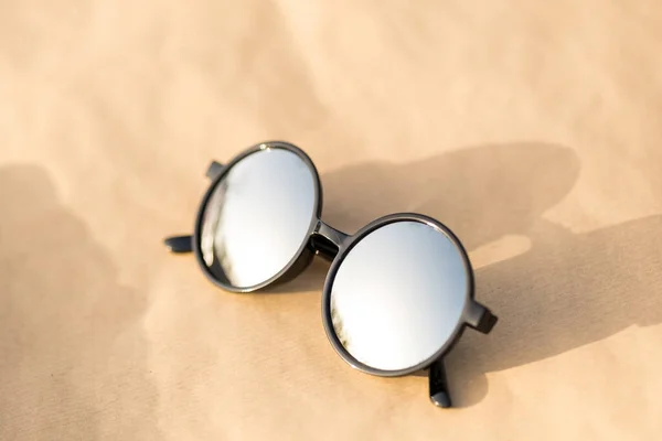 Sunglasses with big silver round lens shoot outdoors in a sunny day closeup. Selective Focus