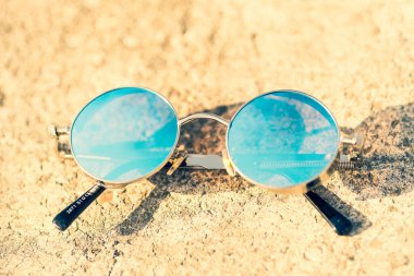 Bir yaz gününde mavi yuvarlak lensli Steampunk güneş gözlüğü modeli. Seçici odak 