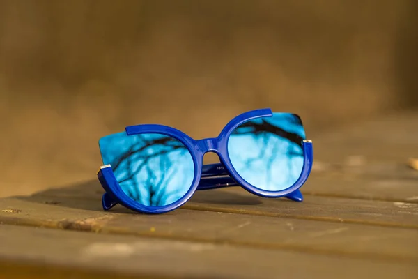 Cat eye sunglasses special model for women with blue lenses shoot outside closeup. Selective focus