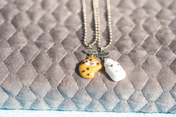 Set of best friends cookie and milk necklace pendant shoot outside in a summer day closeup. Selective Focus — Stock Photo, Image