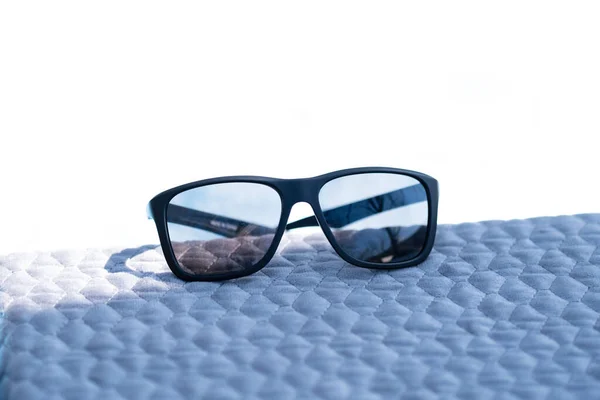 Classic Sunglasses design with black lenses and black frame shoot outside in a sunny day. Selective focus — Stock Photo, Image