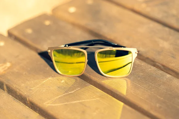 Futuristic sunglasses design with big green lenses closeup shoot outside in a summer day . Selective focus — Stock Photo, Image