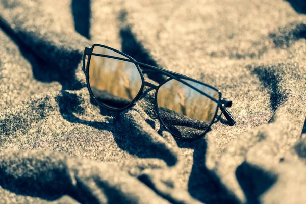 Cat eye sunglasses special model with silver lenses and black frame shoot in a summer day closeup. Selective focus — Stock Photo, Image