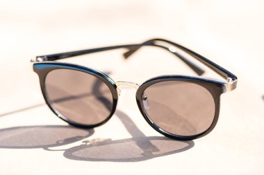 Siyah yuvarlak lensli bayanlar için klasik güneş gözlüğü modeli güneşli bir günde dışarıda çekim yapıyor. Seçici odak