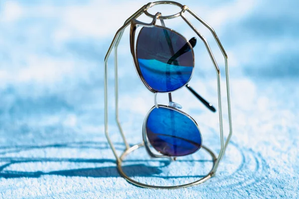 Модна модель сонцезахисних окулярів для котів для жінок з блакитними лінзами та золотою рамкою на вулиці в сонячний день крупним планом. Вибірковий фокус — стокове фото
