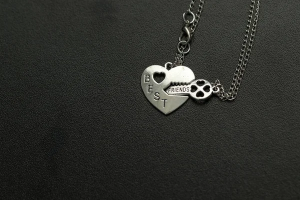 Pendant of best friends heart and key necklace silver color closeup. Selective Focus — Stock Photo, Image