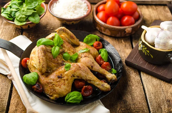 Kip gebakken met tomaten en basilicum op ijzeren pan — Stockfoto