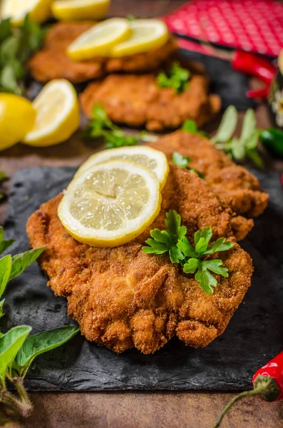 Schnitzel with fries, salad and herbs — Stock Photo, Image