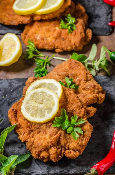 Schnitzel with fries, salad and herbs — Stock Photo, Image