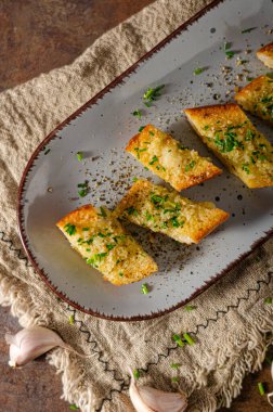 Delicious baguette with butter, parmesan cheese and garlic clipart