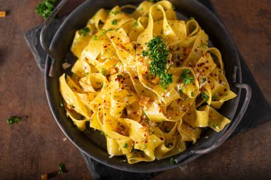 Kızarmış sarımsak ve biberli lezzetli organik pappardelle.