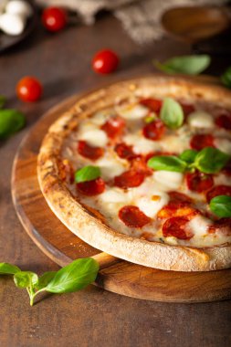 Sıcak salamlı, parmesanlı ve taze fesleğenli lezzetli pizza.