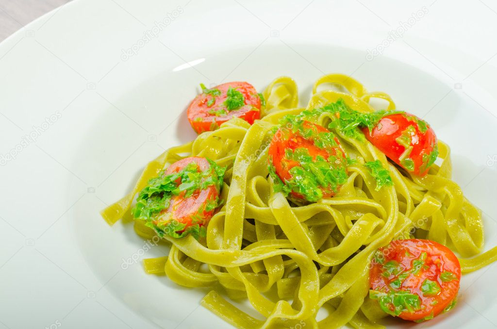 Pasta with basil pesto and pine nuts, cherry tomatoes