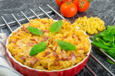 Baked homemade pasta with leeks, bacon and cream clipart