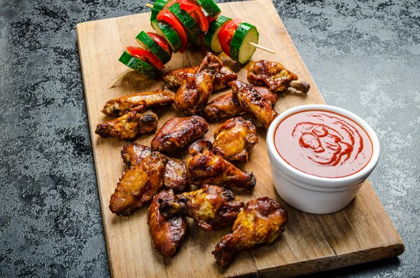 Sticky chicken with red hot dip — Stock Photo, Image