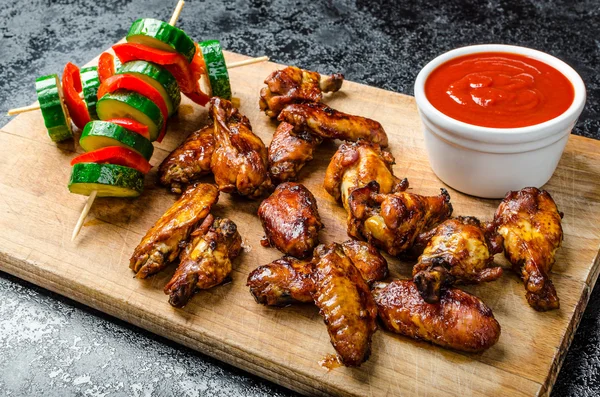 Sticky chicken with red hot dip — Stock Photo, Image