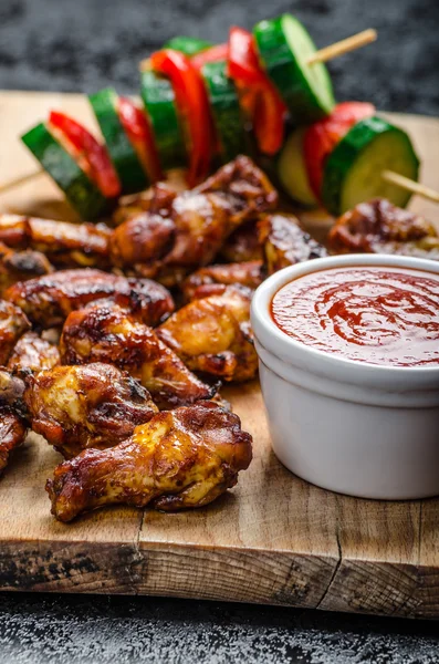 Sticky chicken with red hot dip — Stock Photo, Image