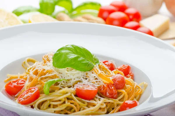 Lemon pasta with cherry tomatoes, basil and nuts — Stock Photo, Image