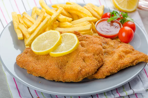 Schnitzel with french fries and a spicy dip — Stock Photo, Image