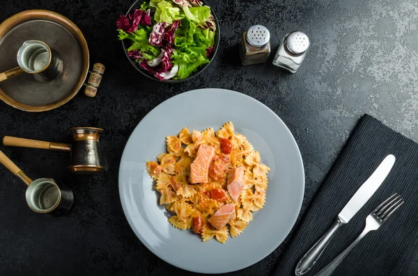 Farfalle with tomato sauce and roasted salmon — Stock Image Farfalle with tomato sauce and roasted salmon Royalty Free Stock Images