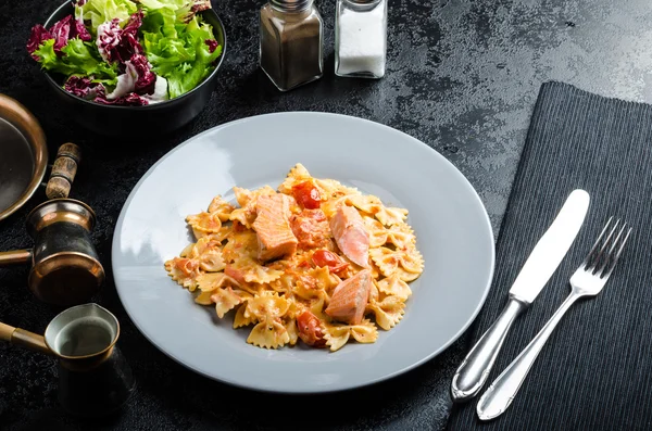 Farfalle with tomato sauce and roasted salmon — Stock Image Farfalle with tomato sauce and roasted salmon Royalty Free Stock Photos