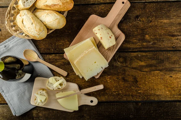 Delicioso queijo maduro com baguete crocante e vinho — Fotografia de Stock