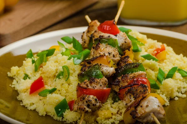 Couscous with vegetables and chicken skewer — Stock Photo, Image