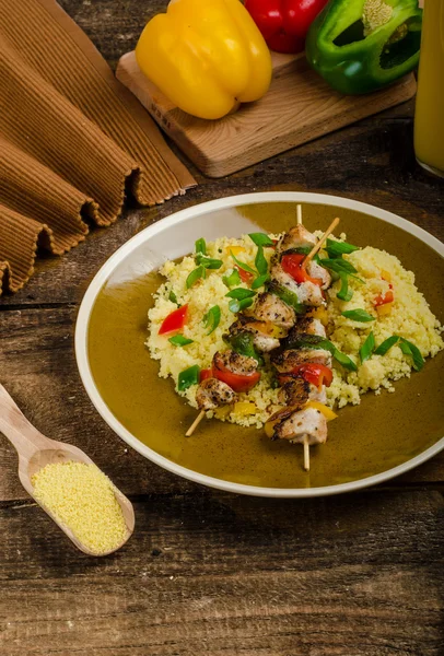Couscous with vegetables and chicken skewer — Stock Photo, Image
