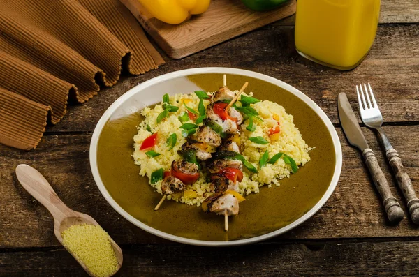 Couscous with vegetables and chicken skewer — Stock Photo, Image