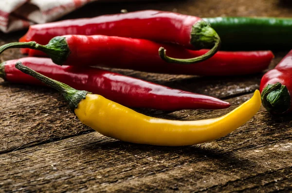 Chilli peppers, wood table, background — Stock Photo, Image