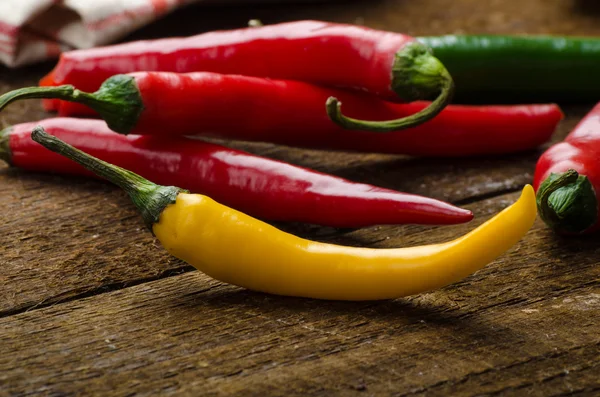 Chilli peppers, wood table, background — Stock Photo, Image