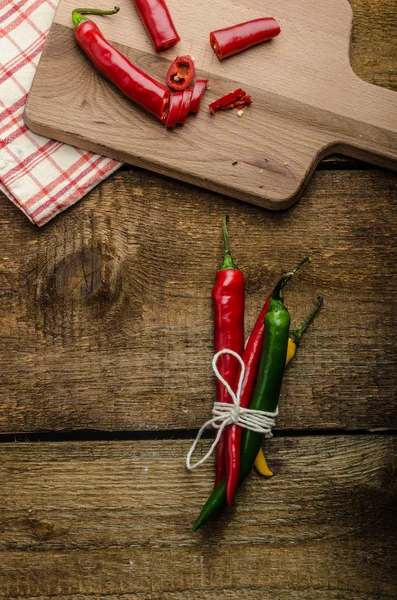 Chilli peppers, wood table, background — Stock Photo, Image