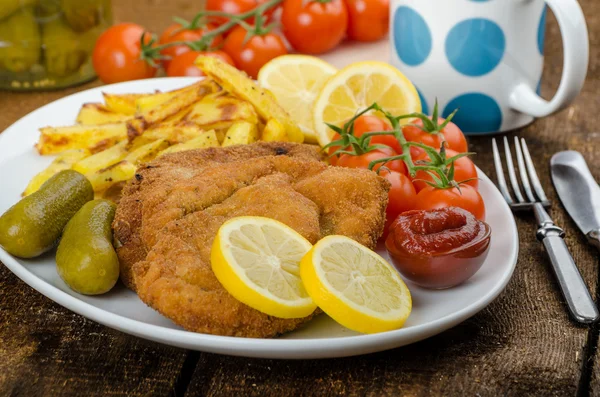 Big Chicken schnitzel with homemade chilli french fries — Stock Photo, Image