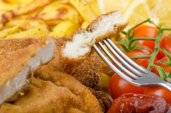Big Chicken schnitzel with homemade chilli french fries — Stock Photo, Image