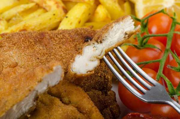 Big Chicken schnitzel with homemade chilli french fries — Stock Photo, Image