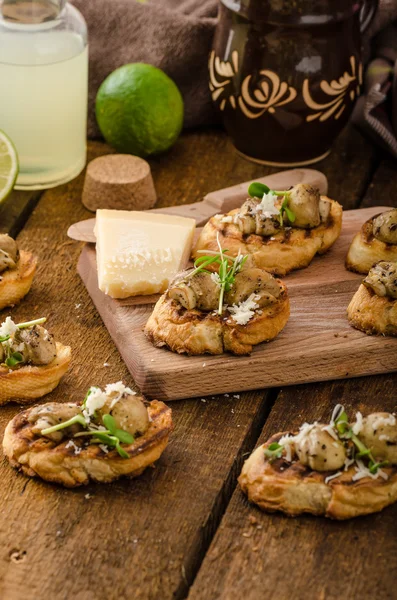 Mushroom snacks on grilled baguette — Stock Photo, Image