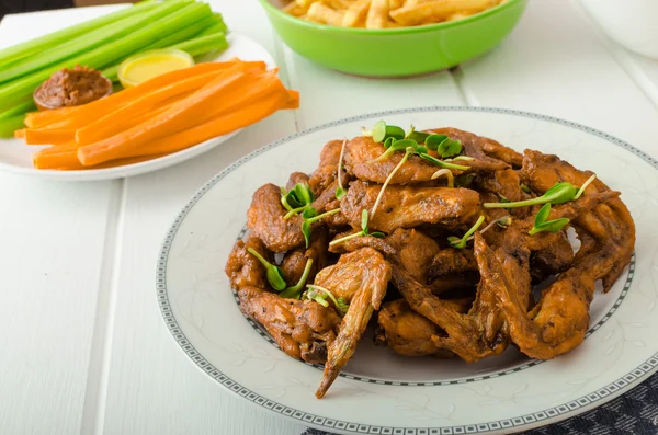 Sports feast - chicken wings, vegetable, french fries, pizza — Stock Photo, Image