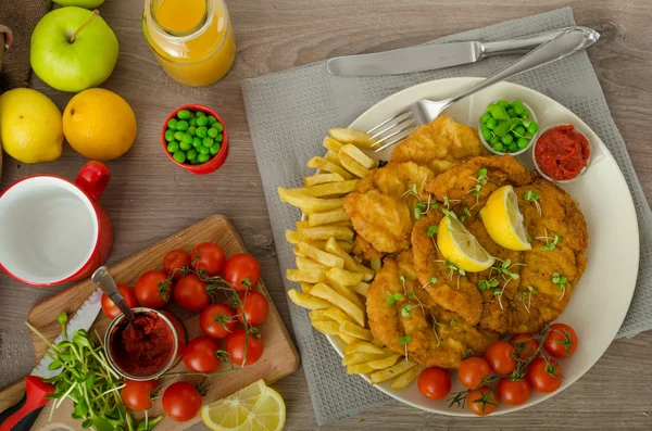 Schnitzel, french fries and microgreens salad — Stock Photo, Image