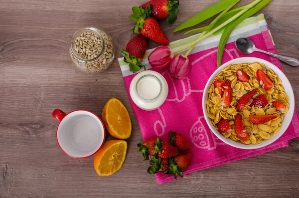 Healthy breakfast cornflakes with milk and fruits