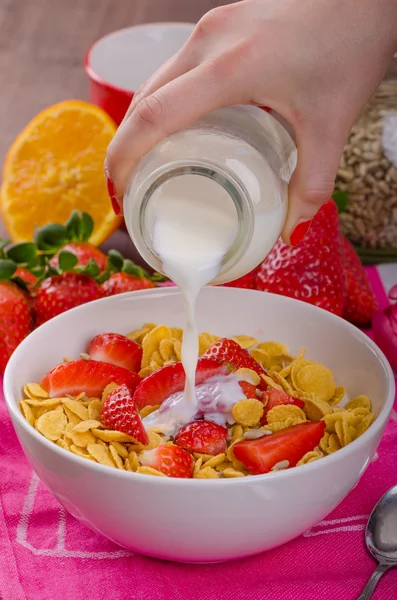Healthy breakfast cornflakes with milk and fruits