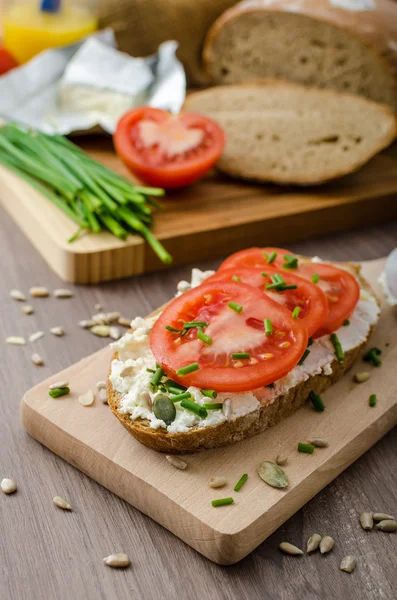 Healthy breakfast - homemade beer bread with cheese, tomatoes and chives