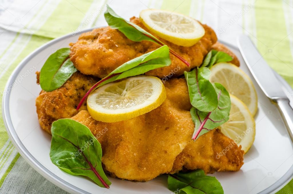 Fried schnitzel with herbs and lemon