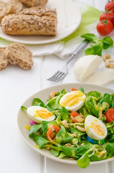 Lamb's lettuce salad with eggs and nuts — Stock Photo, Image