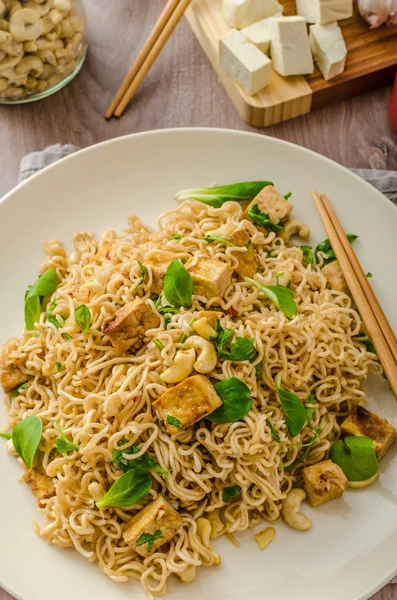 Chinese noodles with tofu and cashew nuts — Stock Photo, Image