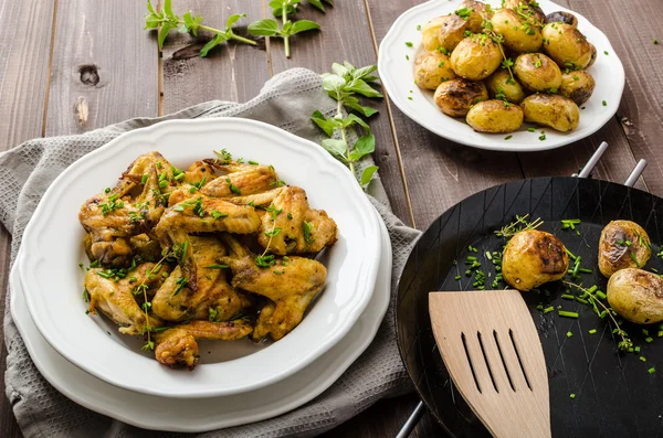 Gebraden kip vleugels met nieuwe aardappel — Stockfoto